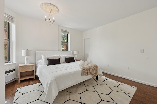 48 W Hamilton Pl Unit 5, Jersey City, NJ 07302 - bedroom with a chandelier, wood finished floors, and a wall mounted AC