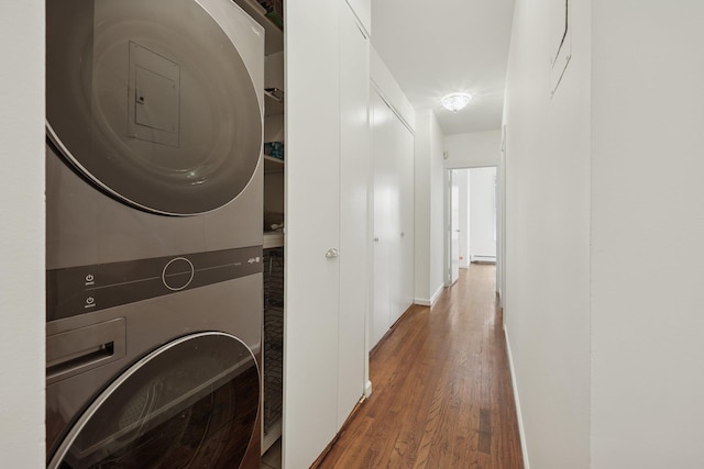 48 W Hamilton Pl Unit 5, Jersey City, NJ 07302 - washroom featuring estacked washer and dryer, wood finished floors, and baseboard heating