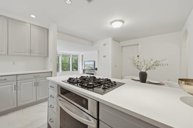 48 W Hamilton Pl Unit 5, Jersey City, NJ 07302 - kitchen featuring stainless steel oven, black gas cooktop, light marble finish floors, gray cabinetry, and recessed lighting