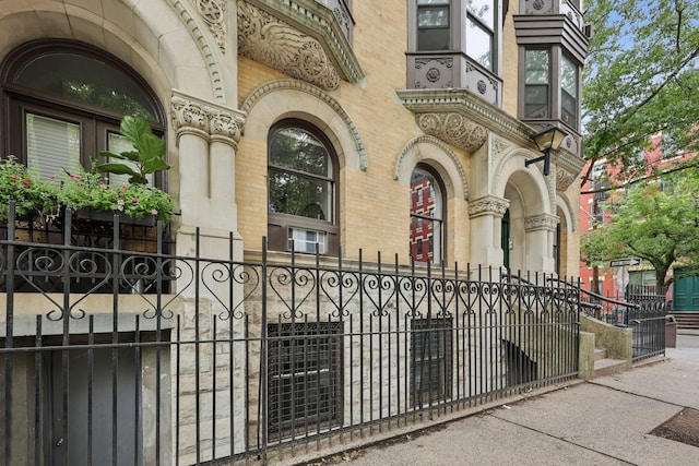 48 W Hamilton Pl Unit 5, Jersey City, NJ 07302 - doorway to property with brick siding, stone siding, and a gate