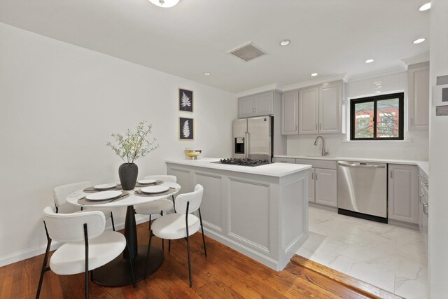 48 W Hamilton Pl Unit 5, Jersey City, NJ 07302 - kitchen with appliances with stainless steel finishes, light countertops, a peninsula, recessed lighting, and gray cabinets