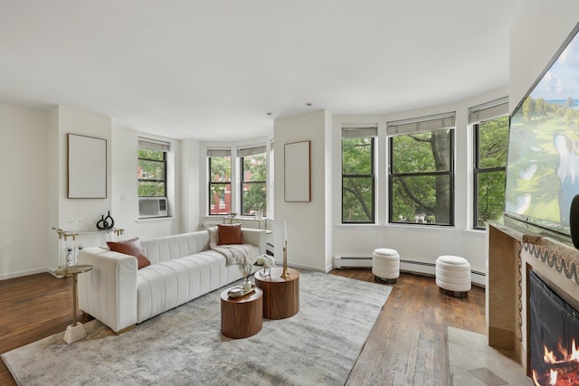 48 W Hamilton Pl Unit 5, Jersey City, NJ 07302 - living area with a warm lit fireplace, hardwood / wood-style floors, a baseboard radiator, and plenty of natural light