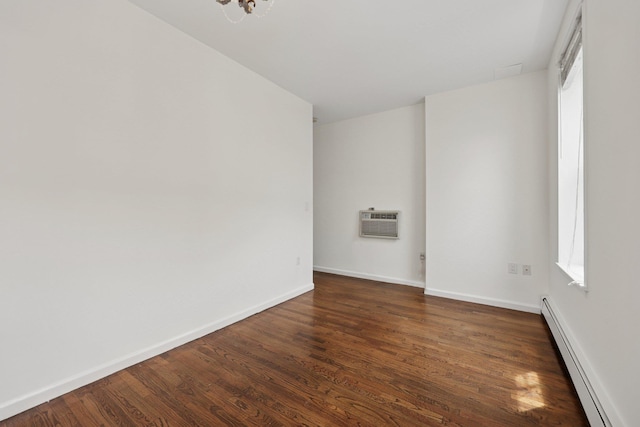 48 W Hamilton Pl Unit 5, Jersey City, NJ 07302 - spare room featuring a baseboard radiator, dark wood-style floors, an AC wall unit, and plenty of natural light