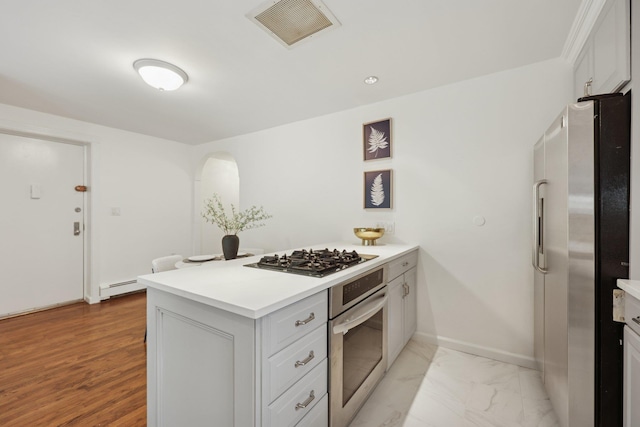 48 W Hamilton Pl Unit 5, Jersey City, NJ 07302 - kitchen featuring appliances with stainless steel finishes, light countertops, a baseboard radiator, and white cabinetry