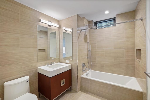 99 Hudson St Unit 401, Jersey City, NJ 07302 - bathroom featuring tiled shower / bath combo, tile walls, toilet, and vanity