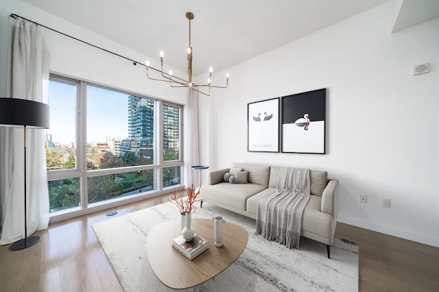 living room with a chandelier and wood-type flooring