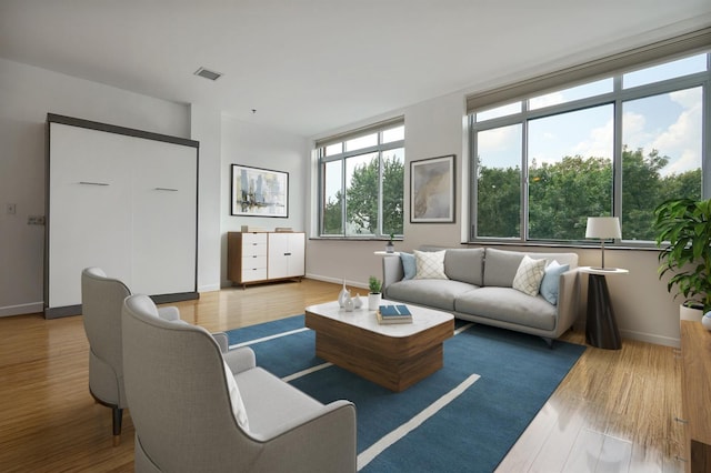 25 Mcwilliams Pl Unit 402, Jersey City, NJ 07302 - living area featuring baseboards, visible vents, and wood finished floors