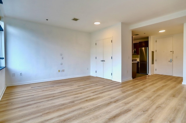 25 Mcwilliams Pl Unit 402, Jersey City, NJ 07302 - unfurnished living room with light wood-style flooring and recessed lighting