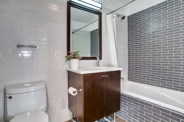 25 Mcwilliams Pl Unit 402, Jersey City, NJ 07302 - bathroom featuring tiled shower / bath combo, vanity, and tile walls