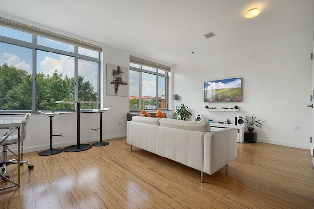 25 Mcwilliams Pl Unit 402, Jersey City, NJ 07302 - living room featuring baseboards, light wood finished floors, and visible vents