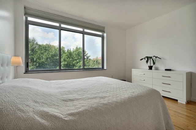 25 Mcwilliams Pl Unit 402, Jersey City, NJ 07302 - bedroom featuring multiple windows and light wood-style flooring
