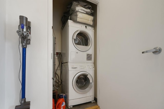 25 Mcwilliams Pl Unit 402, Jersey City, NJ 07302 - washroom featuring wood finished floors and stacked washer / dryer