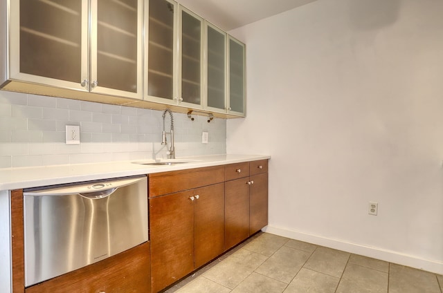25 Mcwilliams Pl Unit 402, Jersey City, NJ 07302 - kitchen with dishwasher, tasteful backsplash, light countertops, light tile patterned floors, and brown cabinets