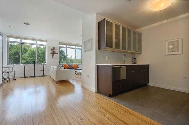 25 Mcwilliams Pl Unit 402, Jersey City, NJ 07302 - kitchen featuring visible vents, light countertops, baseboards, and glass insert cabinets