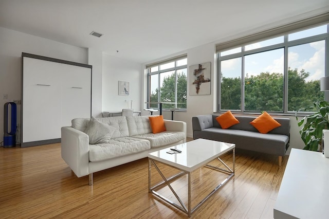 25 Mcwilliams Pl Unit 402, Jersey City, NJ 07302 - living room featuring baseboards, visible vents, and light wood-type flooring