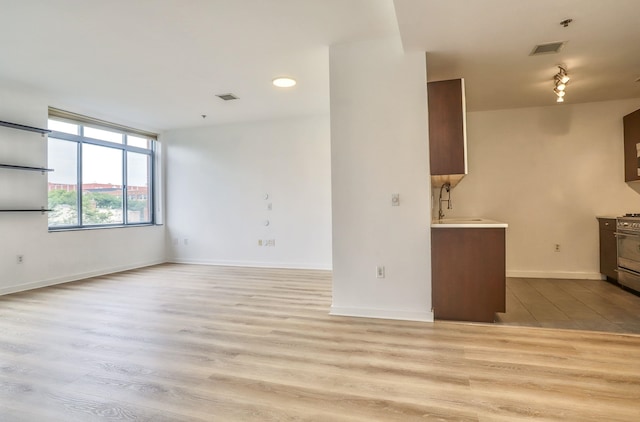 25 Mcwilliams Pl Unit 402, Jersey City, NJ 07302 - unfurnished living room featuring wood finished floors and a sink