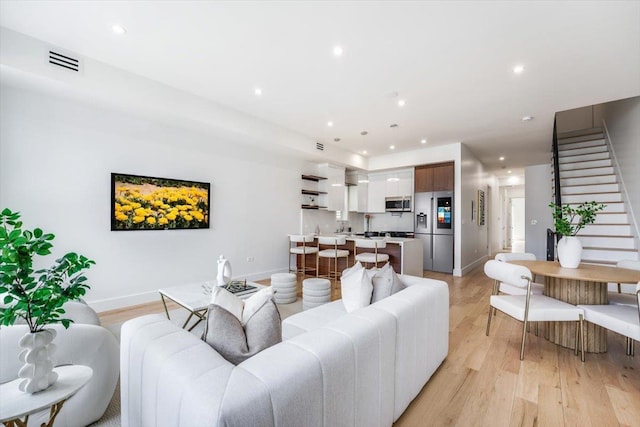 91 Pearsall Ave Unit 2, Jersey City, NJ 07305 - living area with visible vents, light wood-type flooring, stairs, baseboards, and recessed lighting