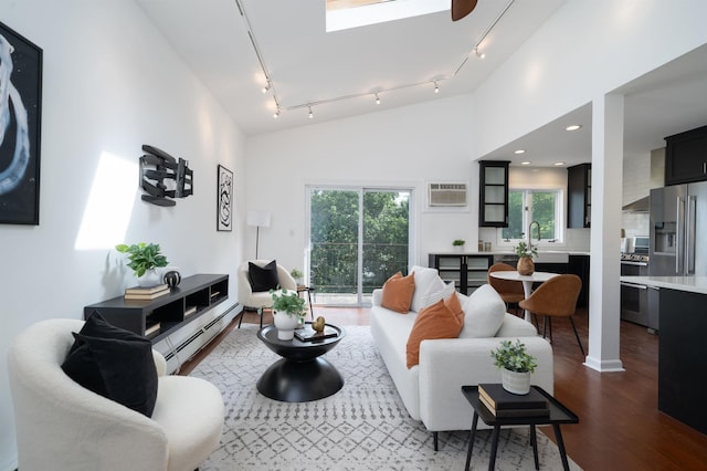 1604 74th St Unit D15, North Bergen, NJ 07047 - living room featuring a baseboard radiator, rail lighting, dark wood-style floors, a wall mounted air conditioner, and recessed lighting