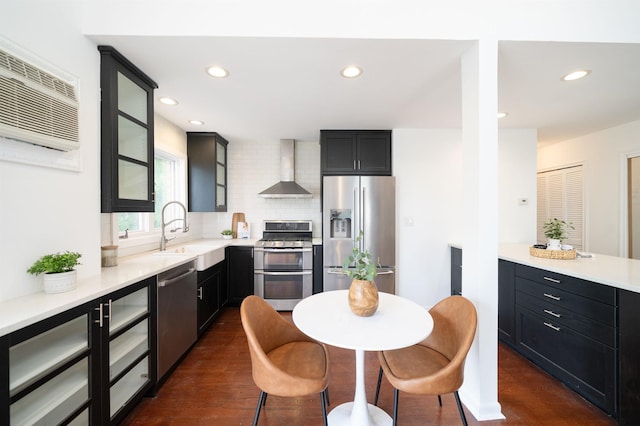 1604 74th St Unit D15, North Bergen, NJ 07047 - kitchen with appliances with stainless steel finishes, wall chimney exhaust hood, dark wood finished floors, recessed lighting, and light countertops