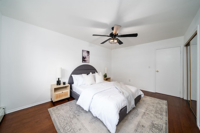 1604 74th St Unit D15, North Bergen, NJ 07047 - bedroom featuring dark wood-type flooring, ceiling fan, a baseboard heating unit, and a closet