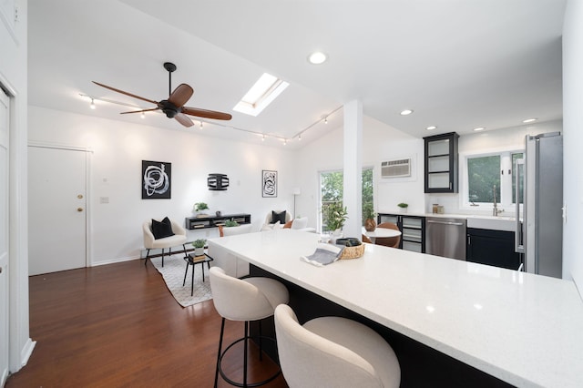1604 74th St Unit D15, North Bergen, NJ 07047 - kitchen with appliances with stainless steel finishes, light countertops, dark wood-style flooring, a breakfast bar, and open floor plan