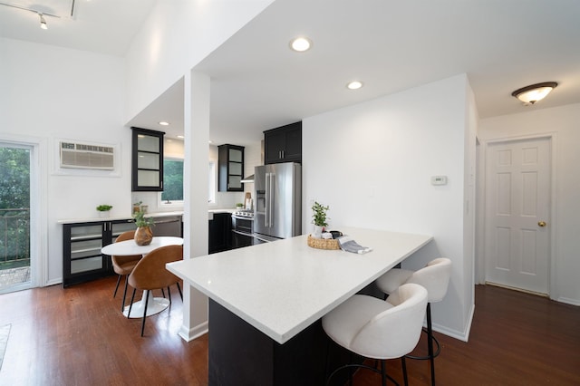 1604 74th St Unit D15, North Bergen, NJ 07047 - kitchen with high quality fridge, a wall unit AC, a breakfast bar, dark wood-type flooring, and recessed lighting