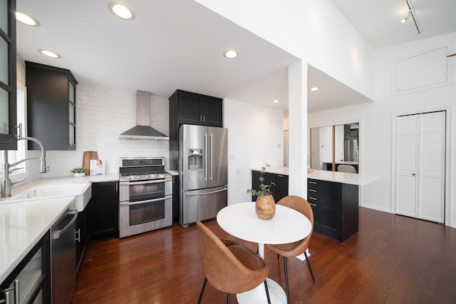 1604 74th St Unit D15, North Bergen, NJ 07047 - kitchen featuring appliances with stainless steel finishes, wall chimney exhaust hood, dark wood-style flooring, decorative backsplash, and recessed lighting