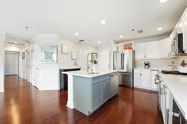 812 Grand St Unit 510, Hoboken, NJ 07030 - kitchen with stainless steel appliances, ornamental molding, dark wood-style floors, a center island with sink, and light countertops