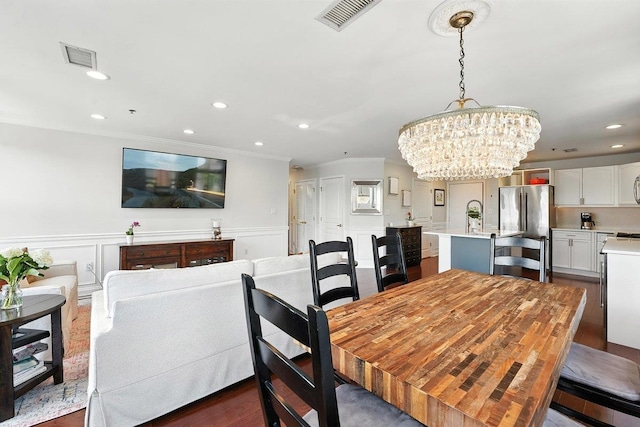812 Grand St Unit 510, Hoboken, NJ 07030 - dining area featuring a chandelier, ornamental molding, a wainscoted wall, recessed lighting, and dark wood-type flooring