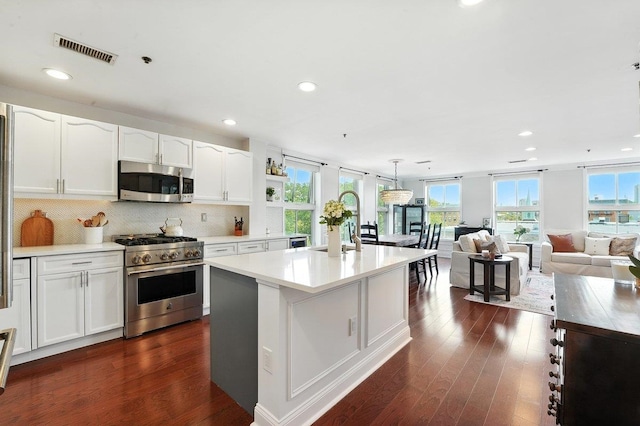 812 Grand St Unit 510, Hoboken, NJ 07030 - kitchen with stainless steel appliances, dark wood-type flooring, white cabinetry, and recessed lighting