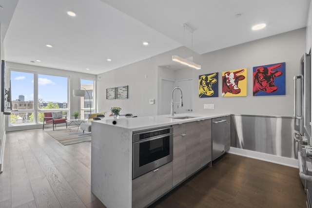 380 Newark Ave Unit 504, Jersey City, NJ 07302 - kitchen with modern cabinets, stainless steel dishwasher, dark wood finished floors, a peninsula, and light countertops