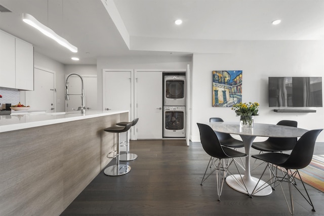 380 Newark Ave Unit 504, Jersey City, NJ 07302 - dining area featuring estacked washer and dryer, dark wood finished floors, and recessed lighting