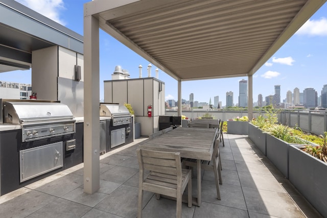 380 Newark Ave Unit 504, Jersey City, NJ 07302 - view of patio / terrace with an outdoor kitchen, a skyline view, and outdoor dining space