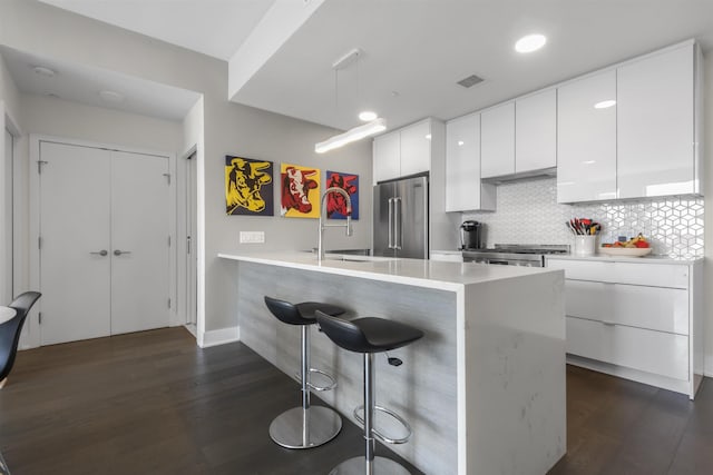 380 Newark Ave Unit 504, Jersey City, NJ 07302 - kitchen featuring high end refrigerator, modern cabinets, a kitchen breakfast bar, and dark wood-style floors