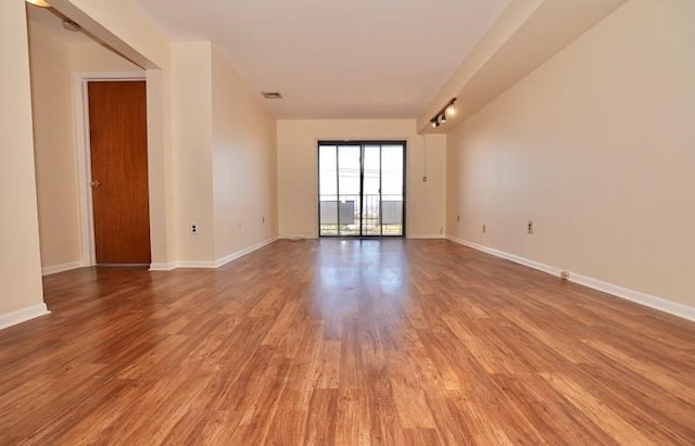 empty room with wood-type flooring