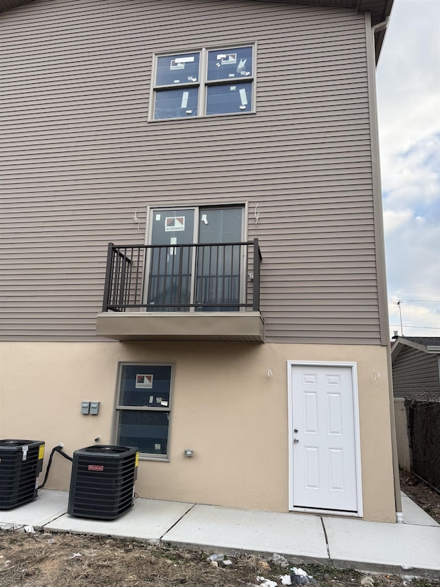 rear view of house with cooling unit