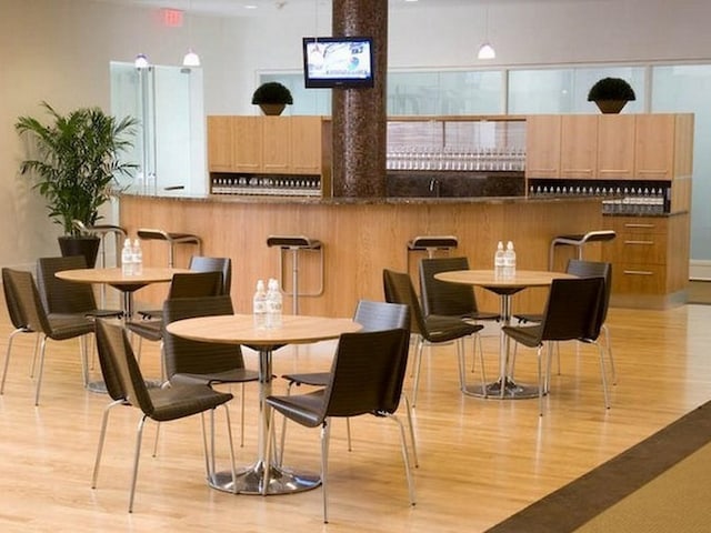 dining room featuring light wood finished floors and a high ceiling