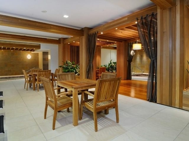 dining space featuring beamed ceiling