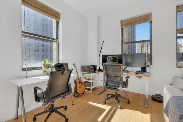 home office with plenty of natural light and wood finished floors