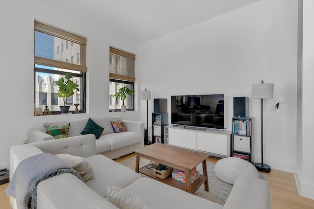 living area with baseboards and light wood-style floors