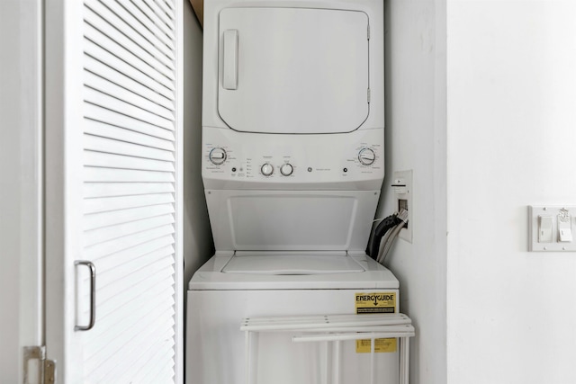 laundry area with laundry area and stacked washer / drying machine