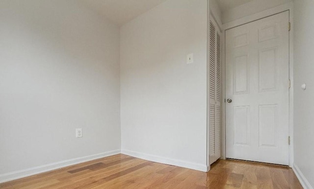 unfurnished bedroom featuring a closet and wood-type flooring