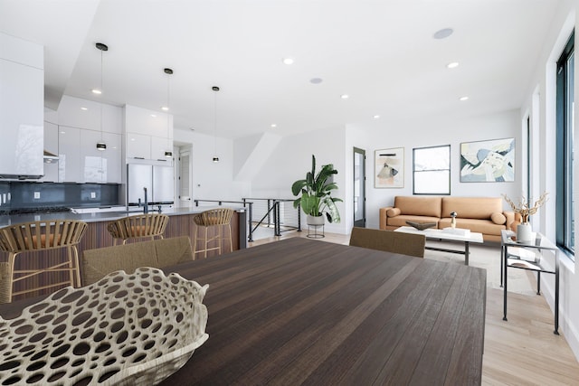 dining space featuring light wood-style floors and recessed lighting