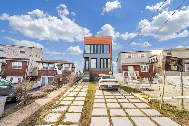 rear view of property featuring a fenced front yard