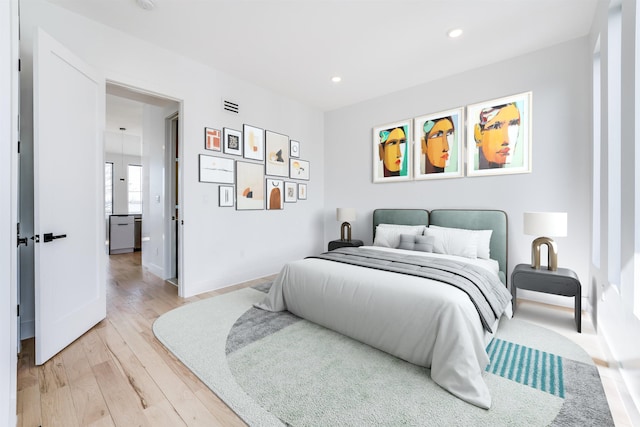 bedroom featuring baseboards, recessed lighting, visible vents, and light wood-style floors