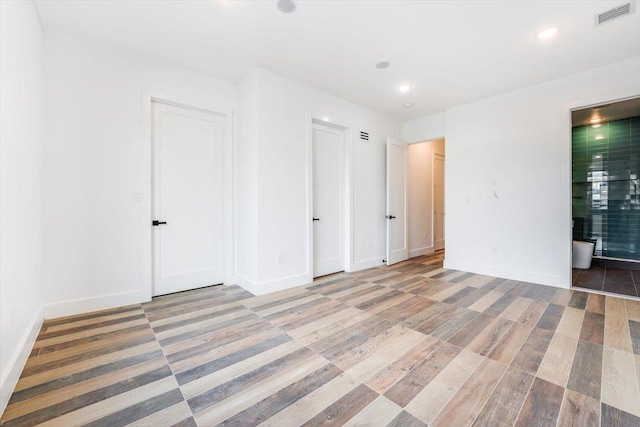 spare room featuring baseboards, visible vents, and recessed lighting