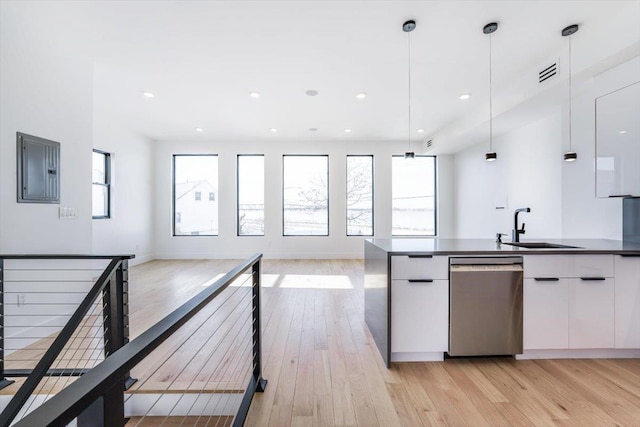 kitchen with visible vents, open floor plan, electric panel, dishwasher, and dark countertops