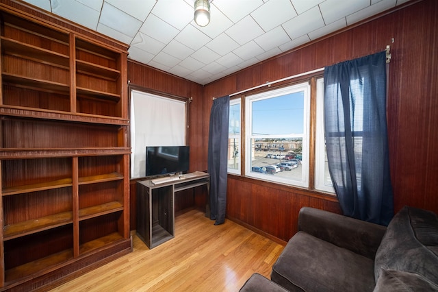 office space featuring light hardwood / wood-style flooring and wooden walls