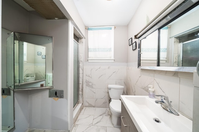 bathroom with vanity, tile walls, an enclosed shower, and toilet