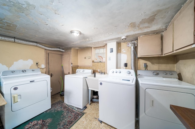 laundry room with cabinets, sink, and washer and dryer